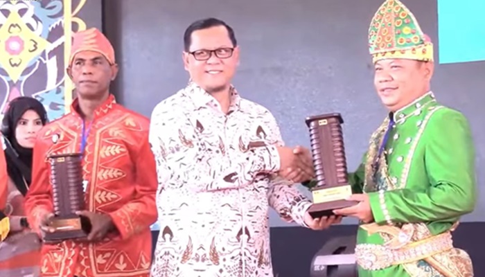 Kepada Desa Tabongo Timur, Hariyanto N Ismail saat menerima penghargaan dari KPK sebagai ‘Desa Anti Korupsi’ kategori Istimewa. [foto:ist/kpk ri)